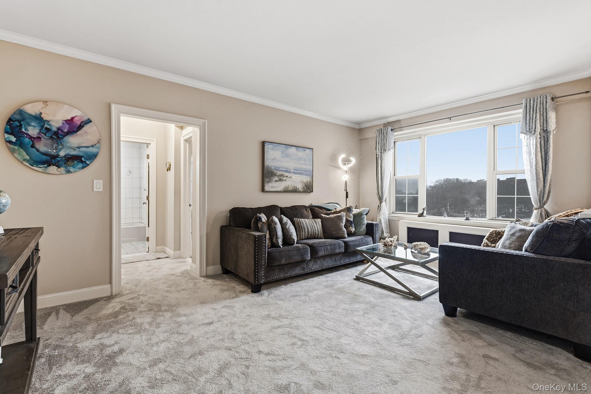 210 Pelham Road, Unit 6E New Rochelle, NY 10805 - Photo 7 of 15 a living room with furniture and a large window