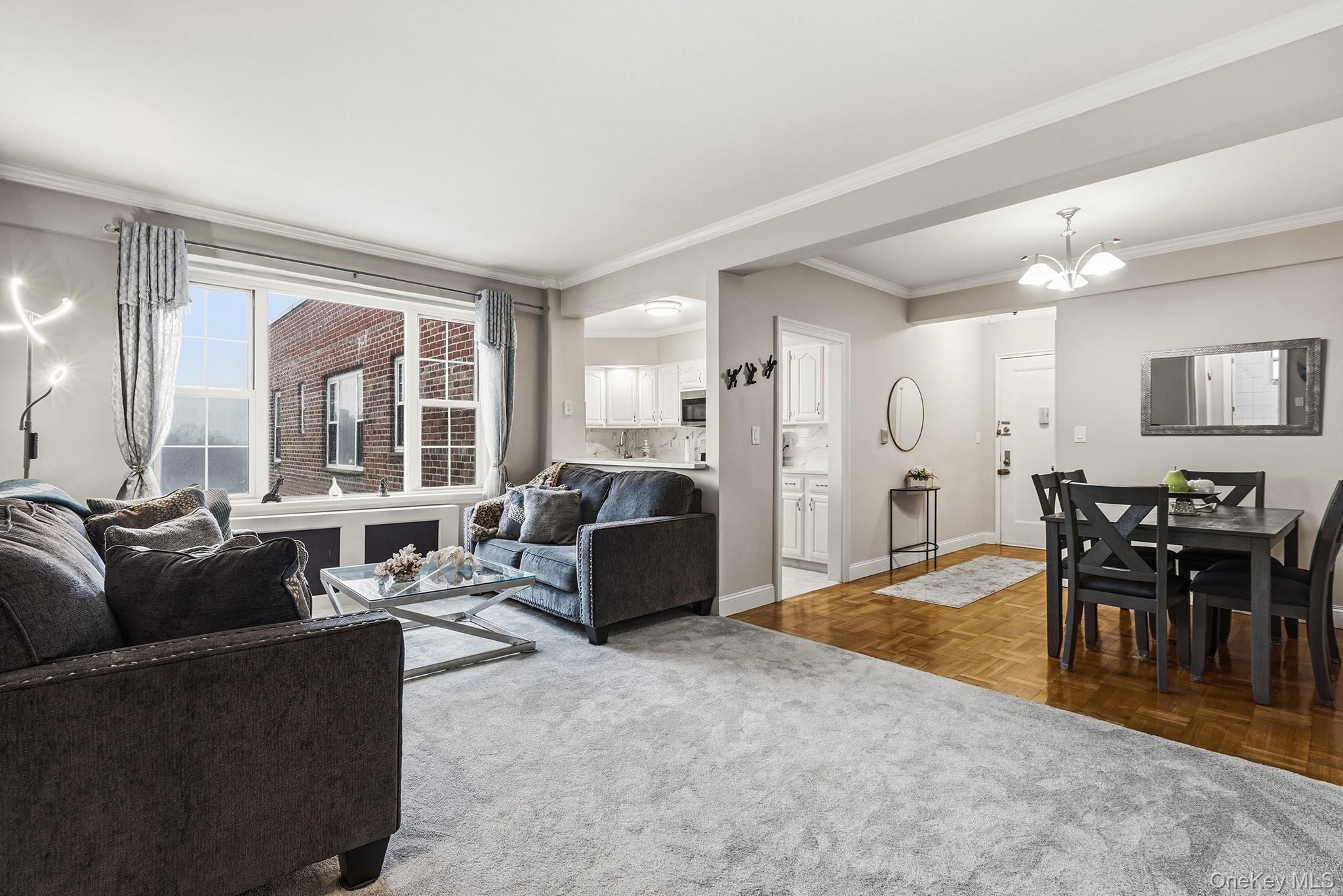 210 Pelham Road, Unit 6E New Rochelle, NY 10805 - Photo 8 of 15 a living room with furniture and a large window