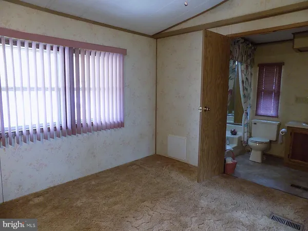 en empty room with windows and a ceiling fan