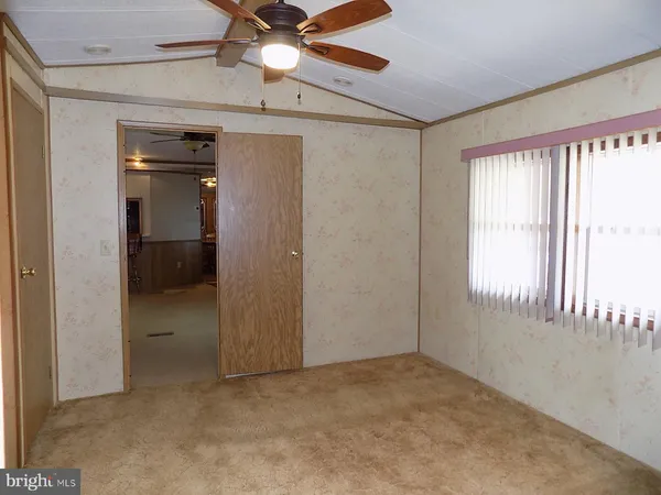 a bathroom with a toilet and a shower curtain