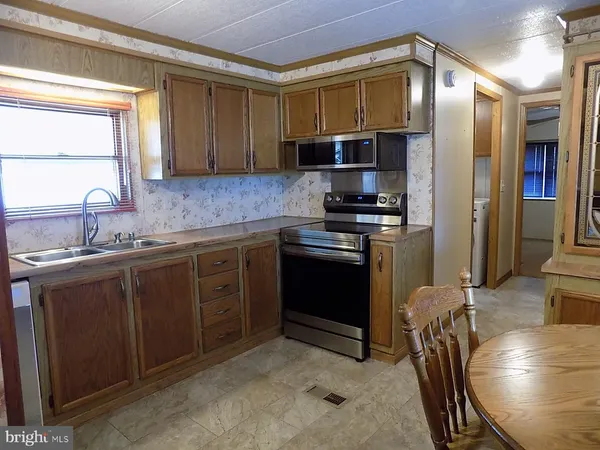 a stove top oven sitting inside of a kitchen