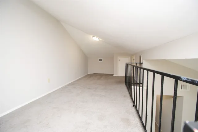 a view of a hallway with stairs