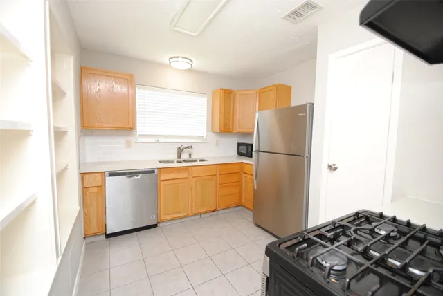 a kitchen with a refrigerator and a sink