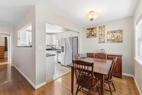 a view of a dining room with furniture and a window