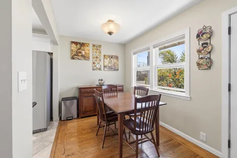 a kitchen with a refrigerator a stove top oven and white cabinets