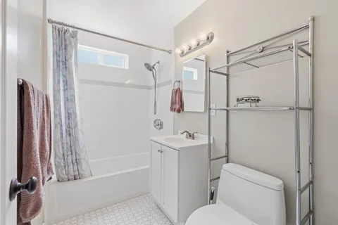 a view of a kitchen with stainless steel appliances granite countertop a stove and cabinets