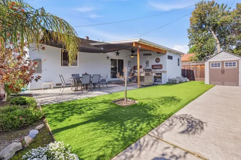 a view of a patio with a table and chairs