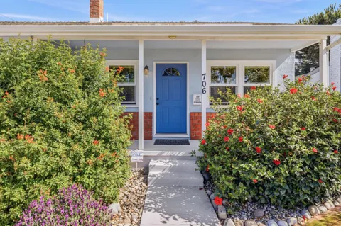 a view of a house with a flower garden