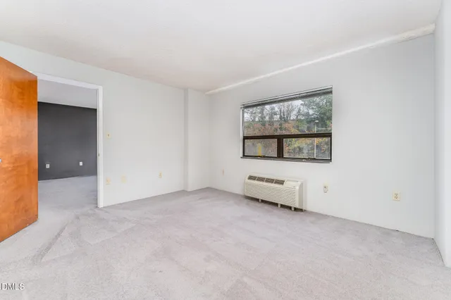 an empty room with windows and closet