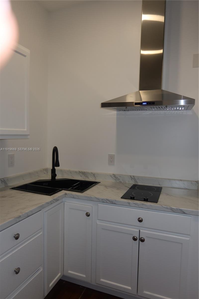 22905 Southwest 114th Place Miami, FL 33170 - Photo 1 of 12 a kitchen with a sink and cabinets