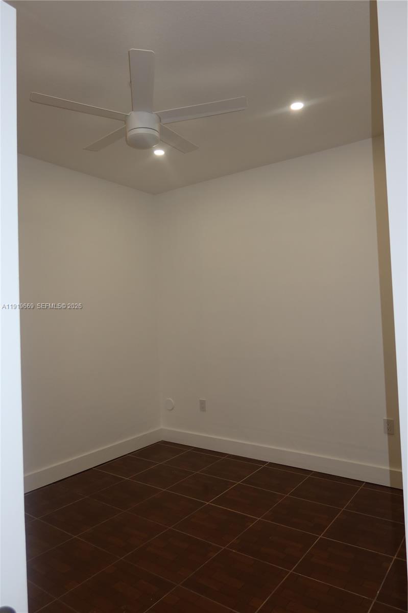 22905 Southwest 114th Place Miami, FL 33170 - Photo 11 of 12 a view of an empty room with wooden floor and a window