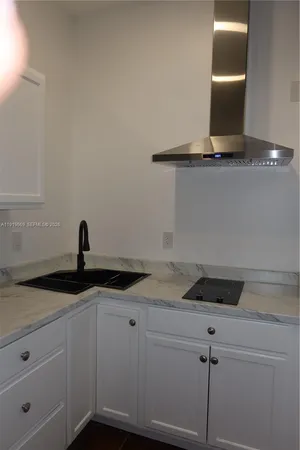 a kitchen with a sink and cabinets