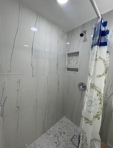 a bathroom with a shower and a sink