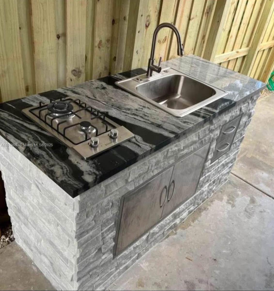 22905 Southwest 114th Place Miami, FL 33170 - Photo 3 of 6 a kitchen with a stove and a sink