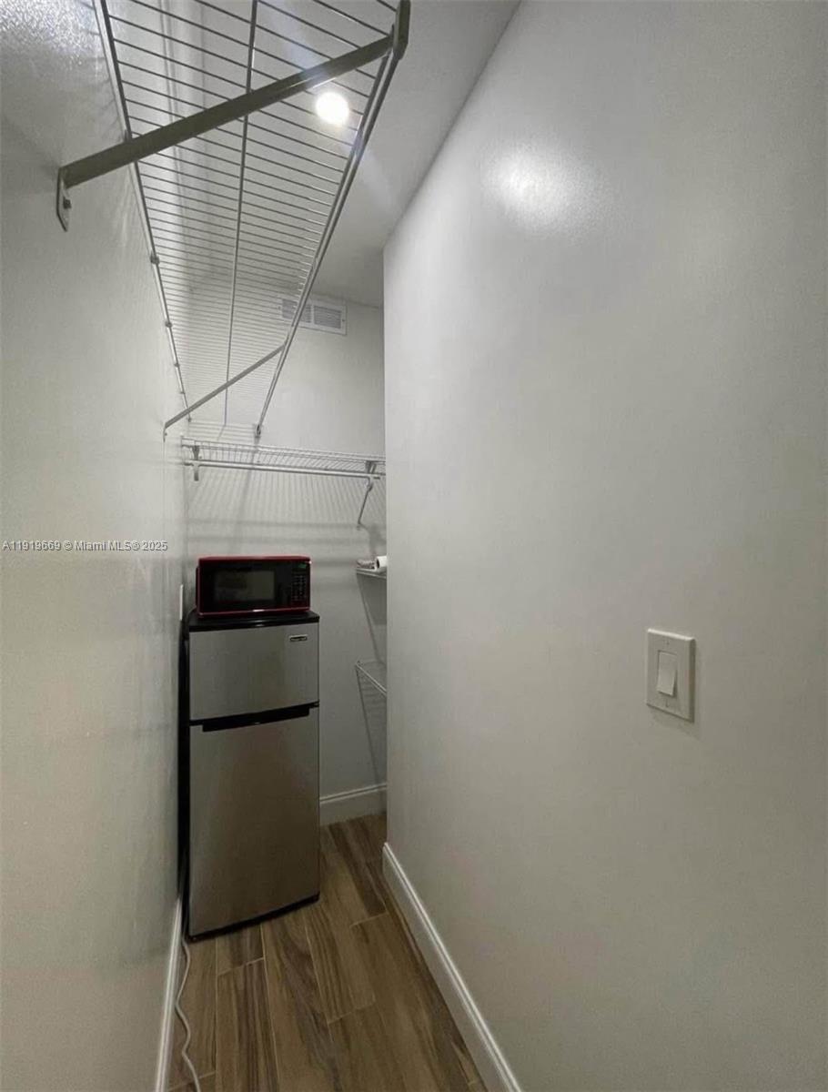 22905 Southwest 114th Place Miami, FL 33170 - Photo 6 of 6 a kitchen with a refrigerator and wooden floor