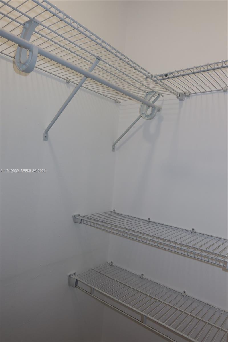 22905 Southwest 114th Place Miami, FL 33170 - Photo 10 of 12 a view of a room with racks on the wall