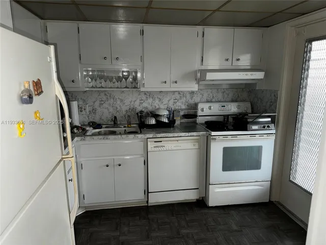 a kitchen with stainless steel appliances granite countertop a sink and a stove