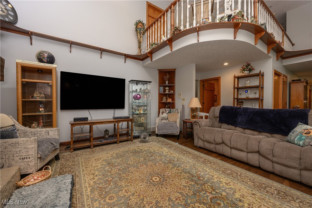 1427 Terrace Road Northwest New Philadelphia, OH 44663 - Photo 25 of 44 Living area with wood finished floors, a towering ceiling, and built in shelves