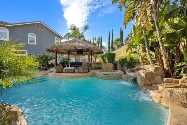 a view of a house with backyard and sitting area