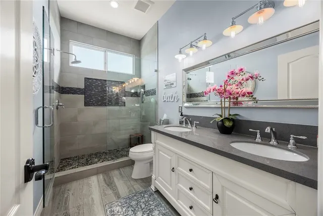 a bathroom with a tub sink shower and mirror