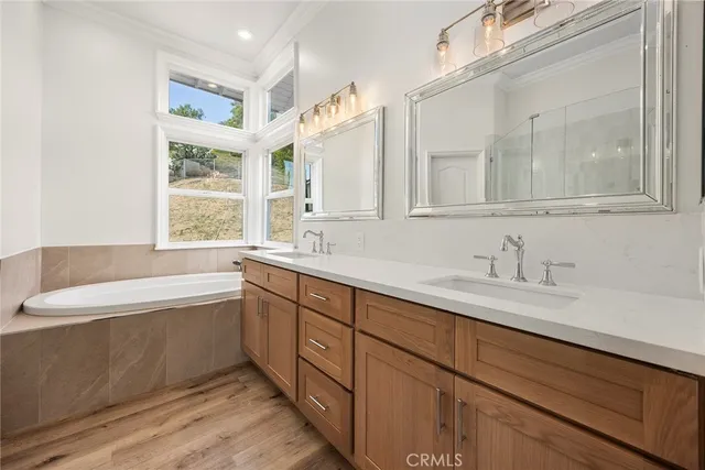 a bedroom with a large bed a flat screen tv and a couch