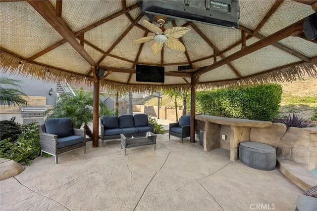 a view of a porch with furniture and garden