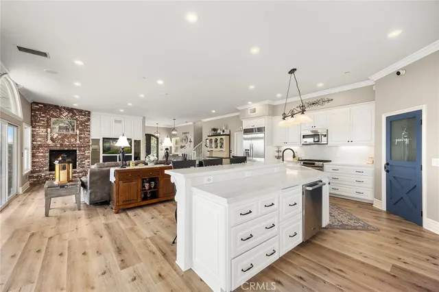 a kitchen with stainless steel appliances kitchen island granite countertop a sink and cabinets