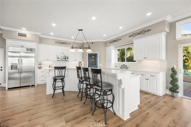 a kitchen with lots of counter top space and wooden floor
