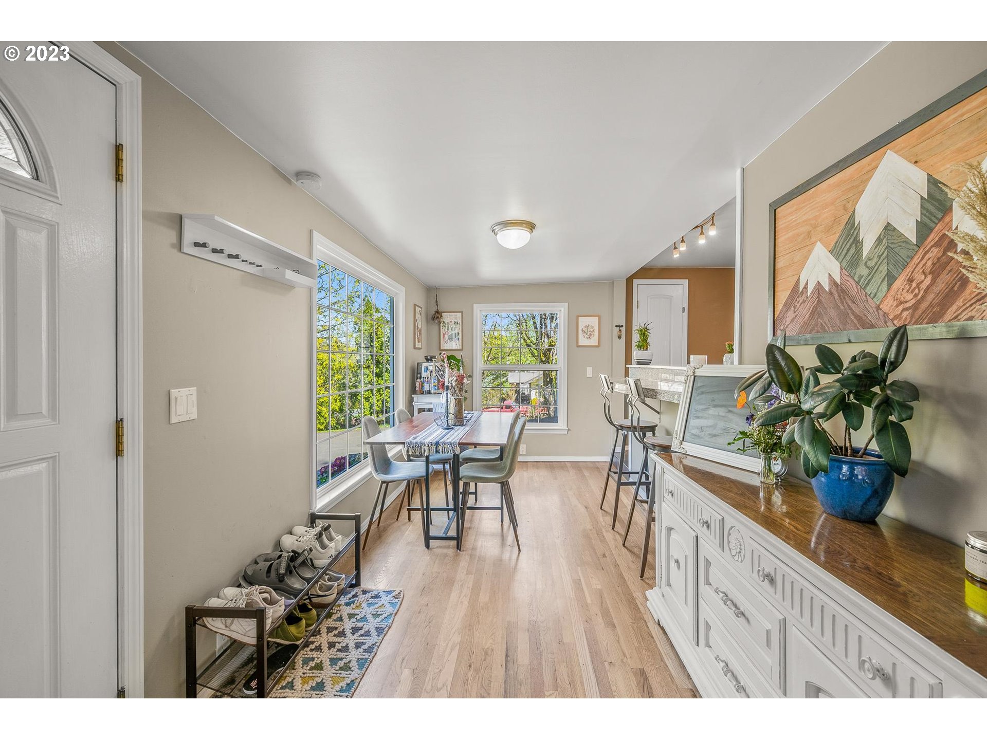 4052 Southwest Huber Street Portland, OR 97219 - Photo 13 of 48 a dining room with furniture and wooden floor