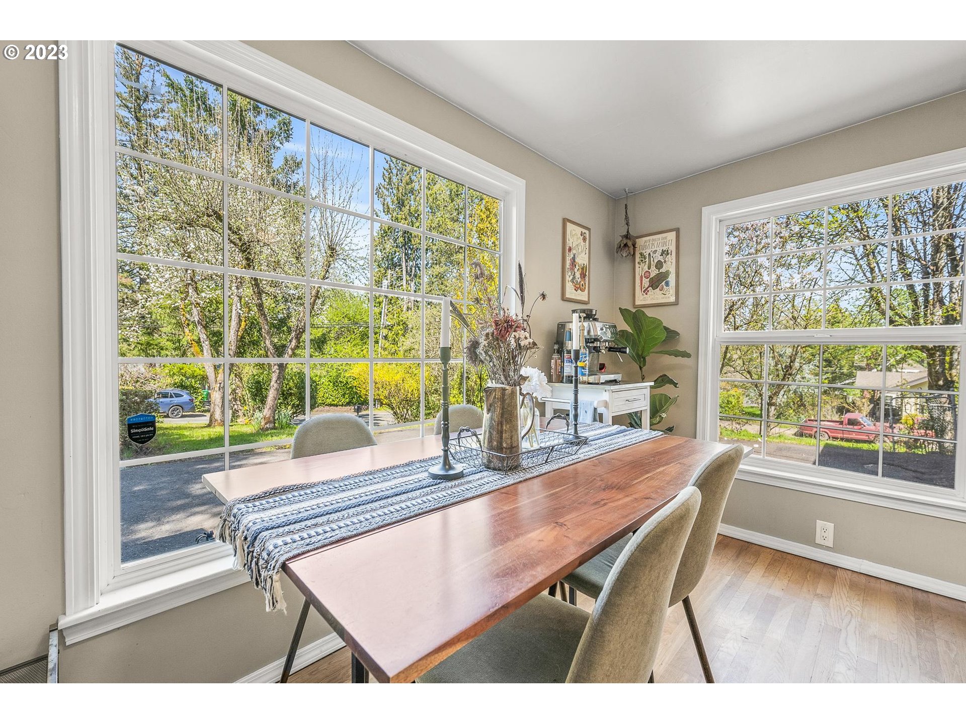 4052 Southwest Huber Street Portland, OR 97219 - Photo 14 of 48 a dining room with furniture and a floor to ceiling window