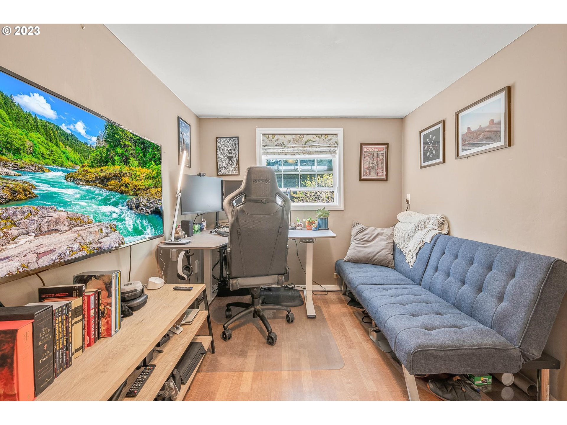 4052 Southwest Huber Street Portland, OR 97219 - Photo 19 of 48 a living room with furniture a flat screen tv and floor to ceiling windows