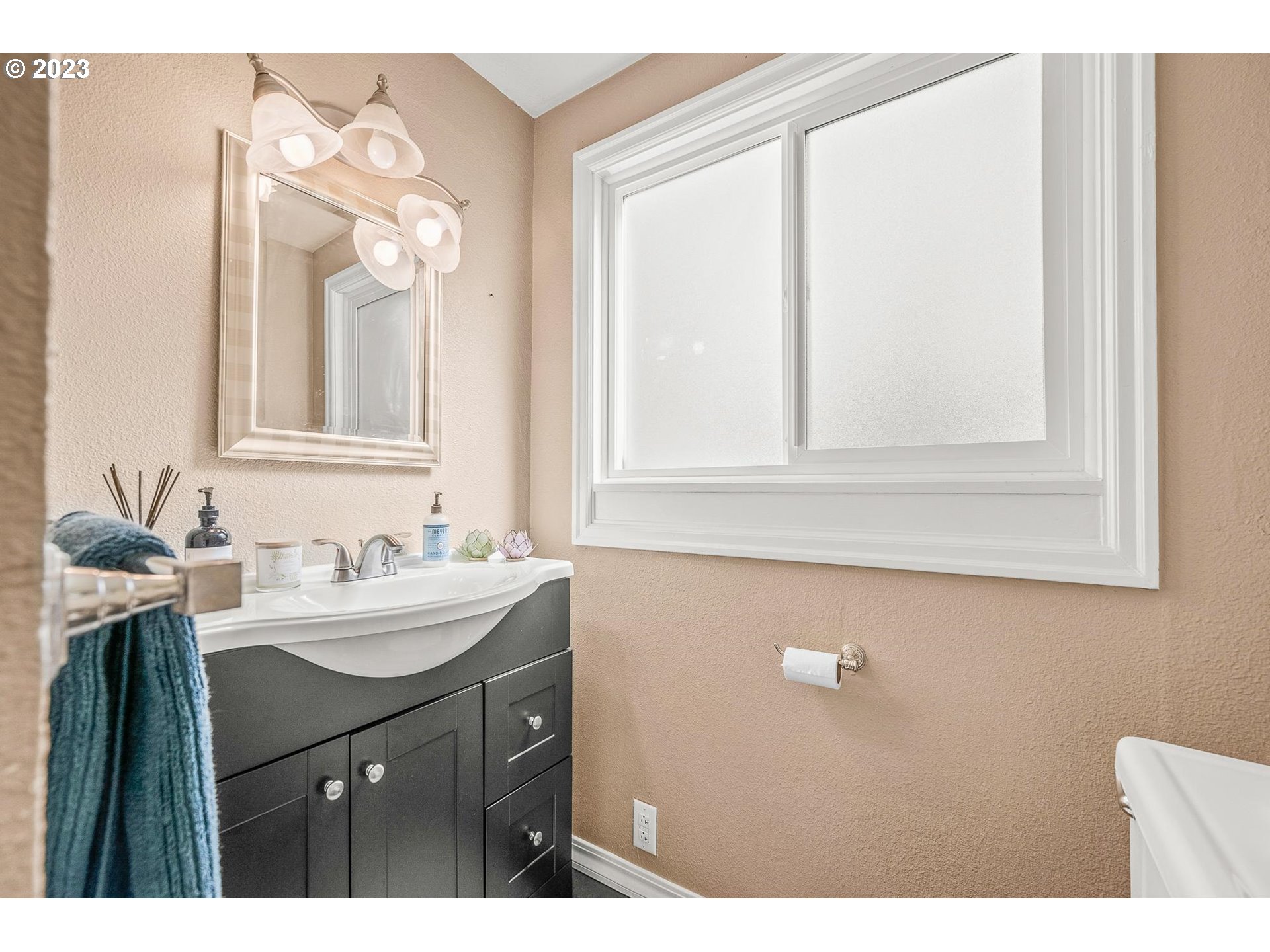 4052 Southwest Huber Street Portland, OR 97219 - Photo 20 of 48 a bathroom with a sink vanity and a mirror