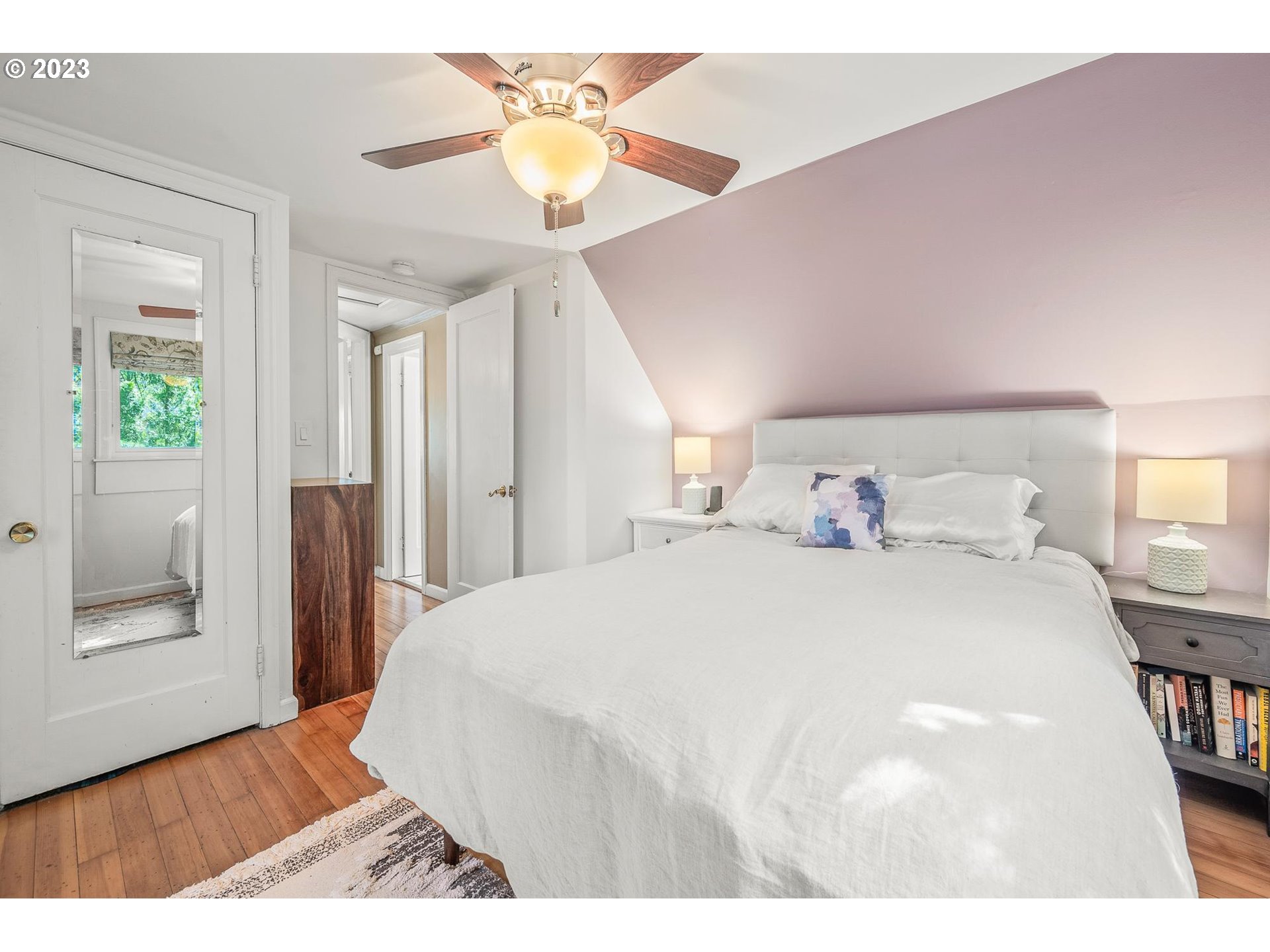 4052 Southwest Huber Street Portland, OR 97219 - Photo 28 of 48 a bedroom with a bed and a chandelier