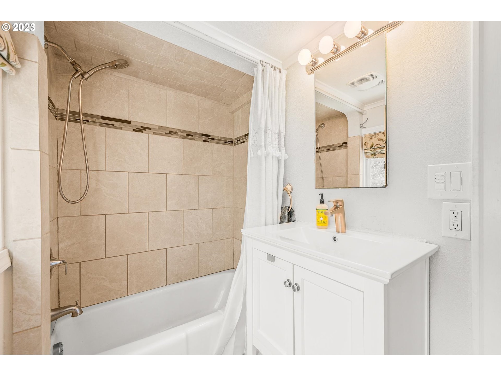 4052 Southwest Huber Street Portland, OR 97219 - Photo 29 of 48 a bathroom with a sink mirror and shower