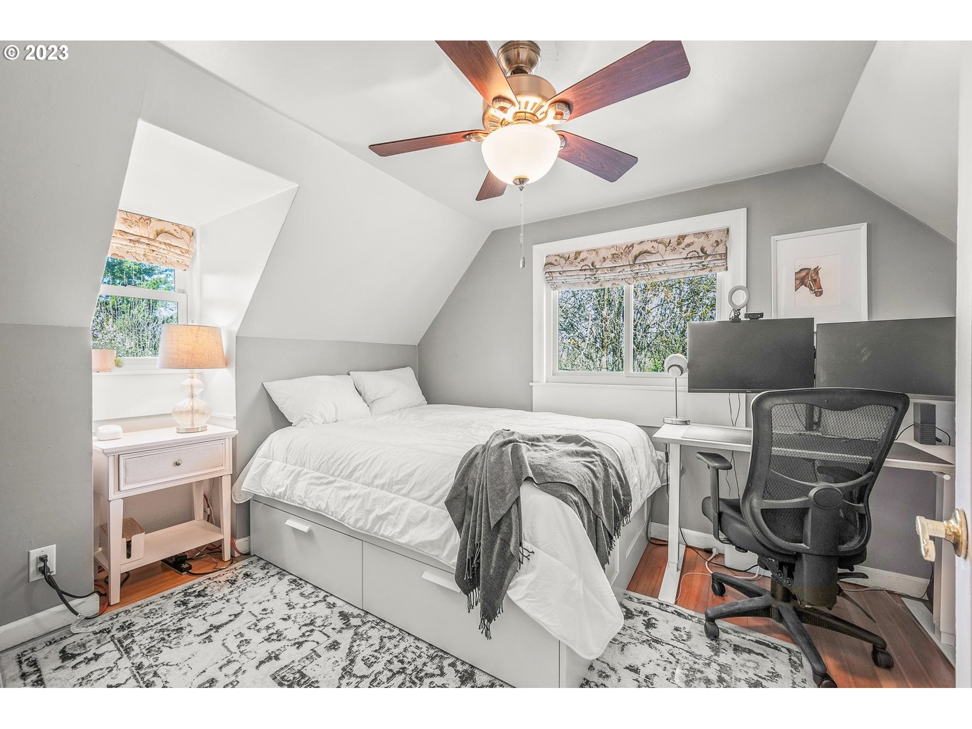 4052 Southwest Huber Street Portland, OR 97219 - Photo 30 of 48 a bedroom with a bed and a chair