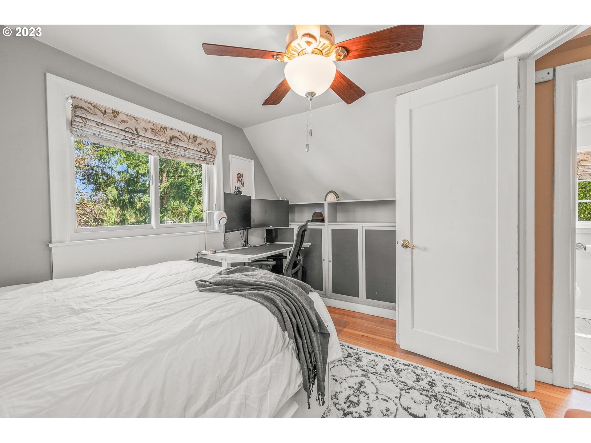 4052 Southwest Huber Street Portland, OR 97219 - Photo 31 of 48 a bedroom with a bed and a large window