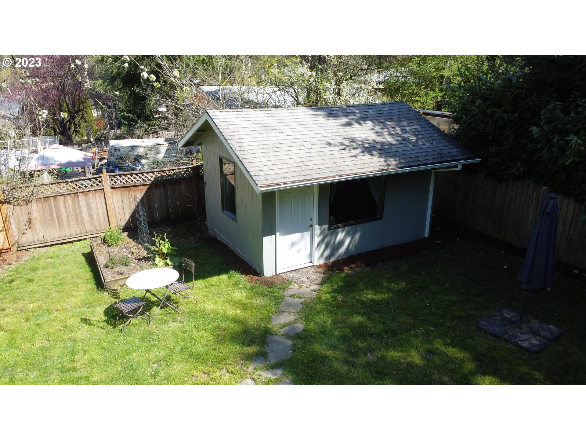 4052 Southwest Huber Street Portland, OR 97219 - Photo 35 of 48 a view of a backyard with a garden and plants