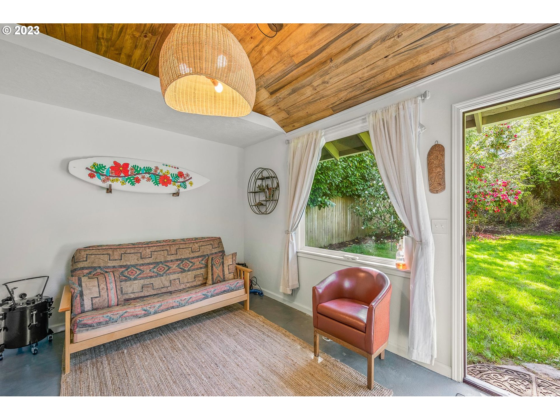 4052 Southwest Huber Street Portland, OR 97219 - Photo 37 of 48 a bedroom with a bed and a chair