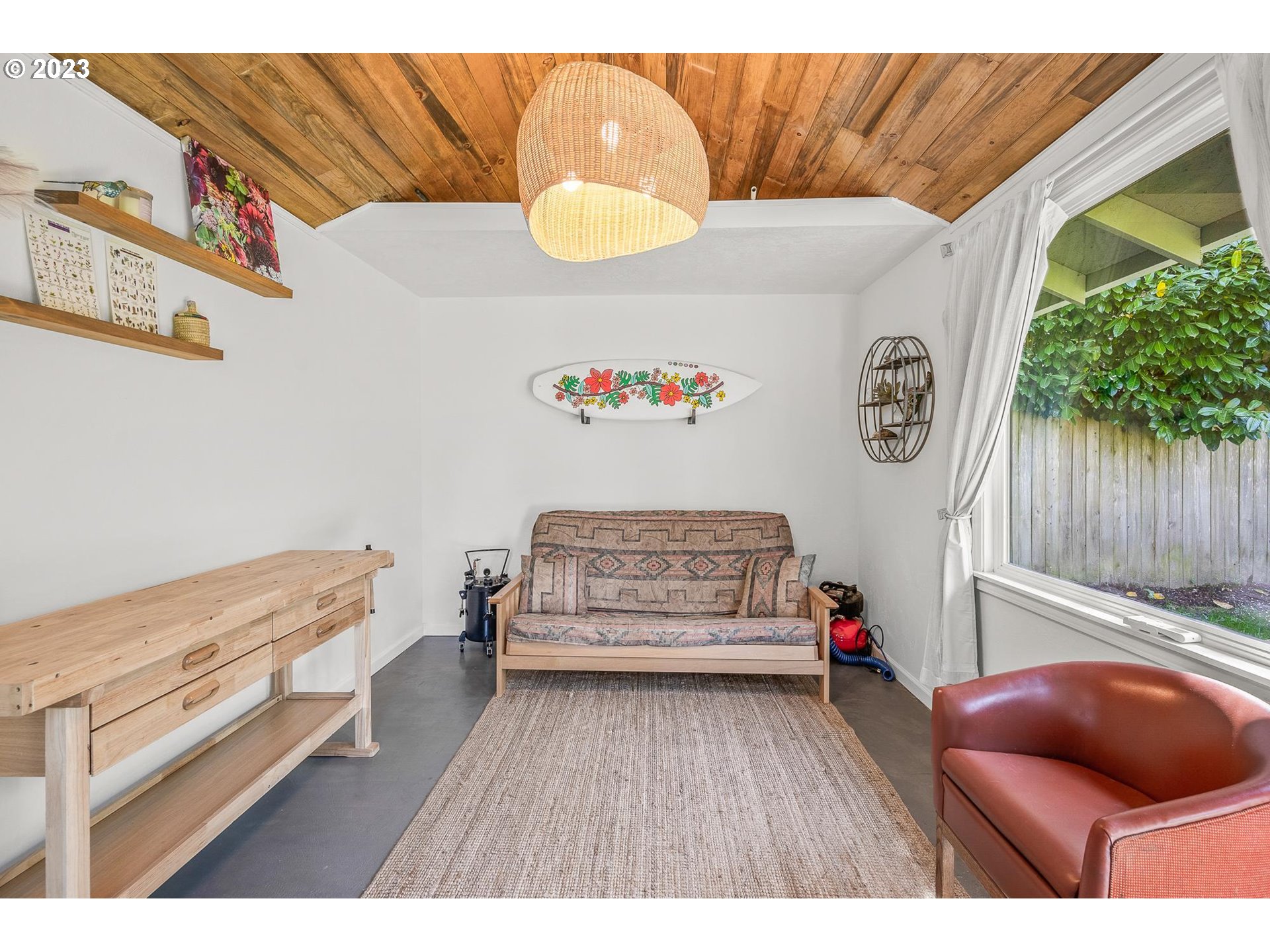 4052 Southwest Huber Street Portland, OR 97219 - Photo 39 of 48 a bedroom with furniture and a wooden floor