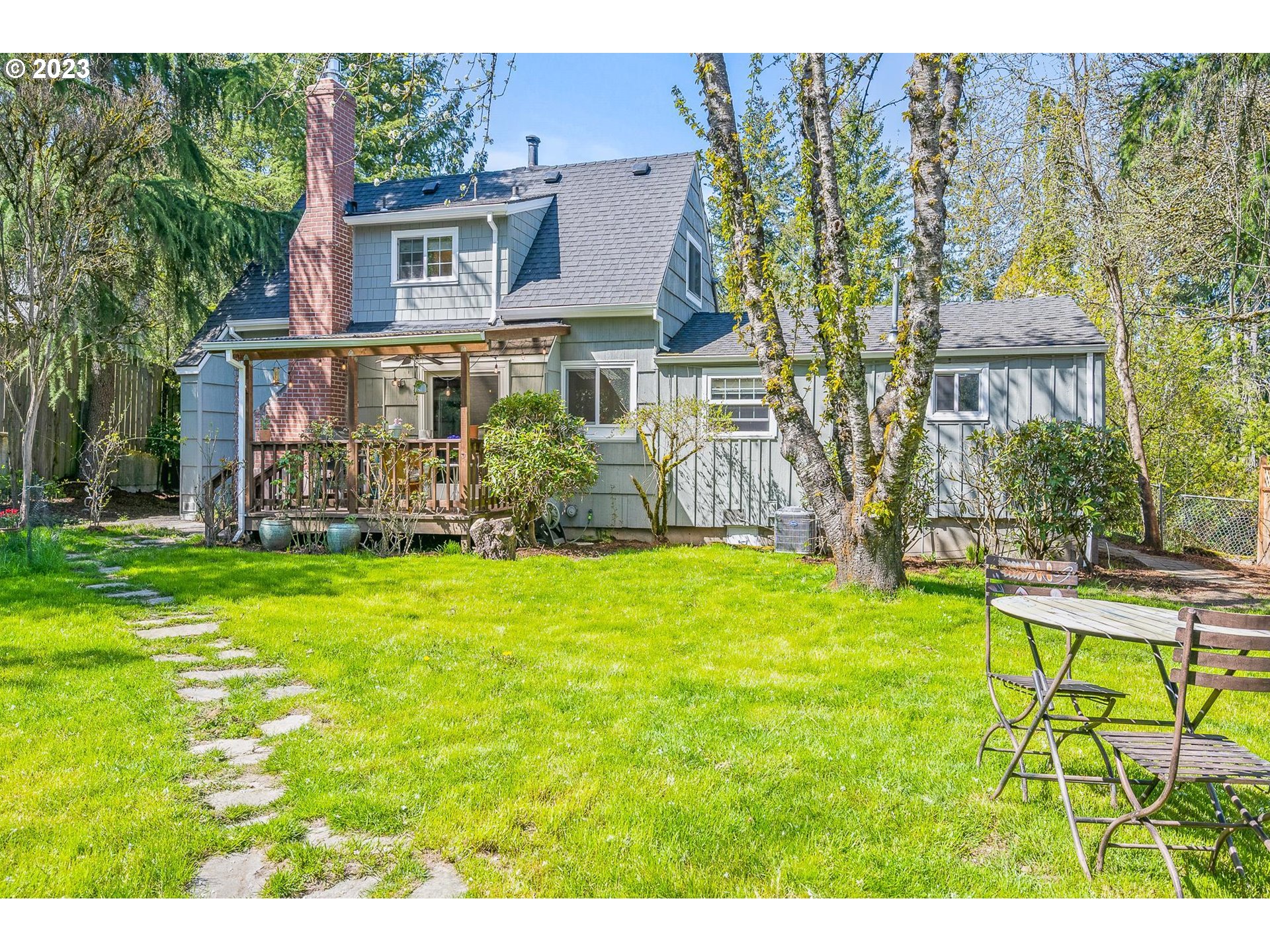 4052 Southwest Huber Street Portland, OR 97219 - Photo 42 of 48 a view of a patio with table and chairs and potted plants