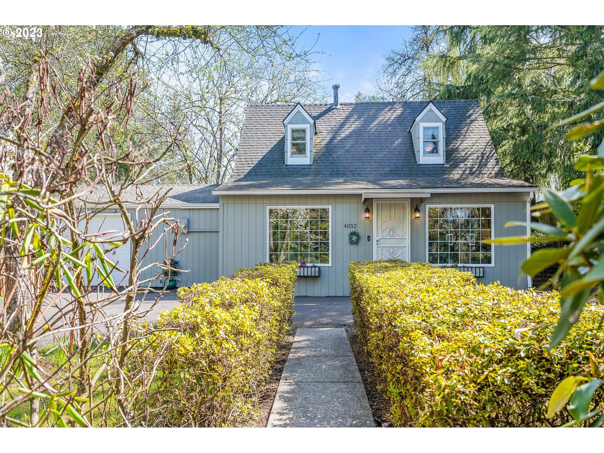 4052 Southwest Huber Street Portland, OR 97219 - Photo 5 of 48 a front view of a house with a garden