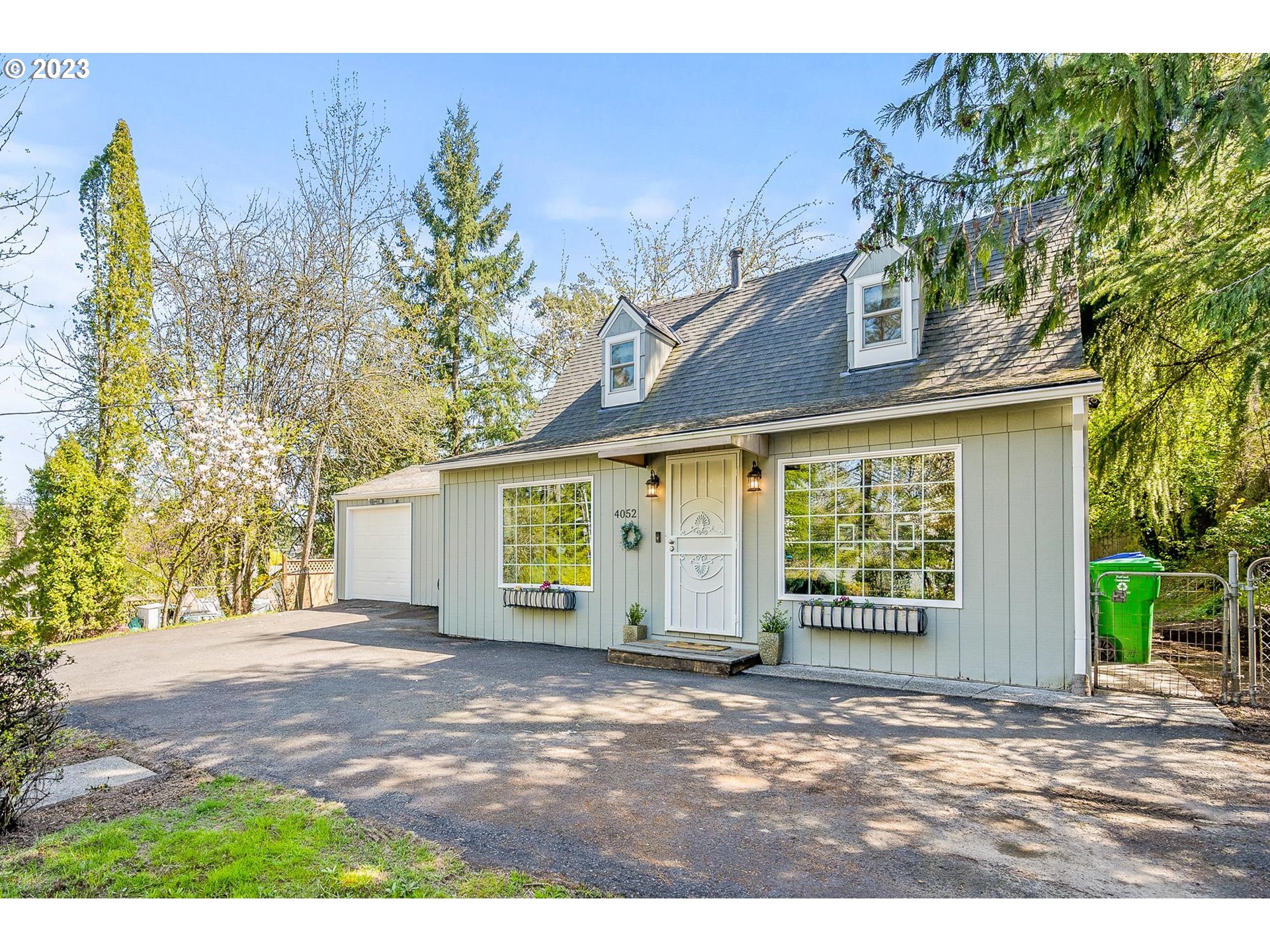 4052 Southwest Huber Street Portland, OR 97219 - Photo 6 of 48 a view of a house with a garden