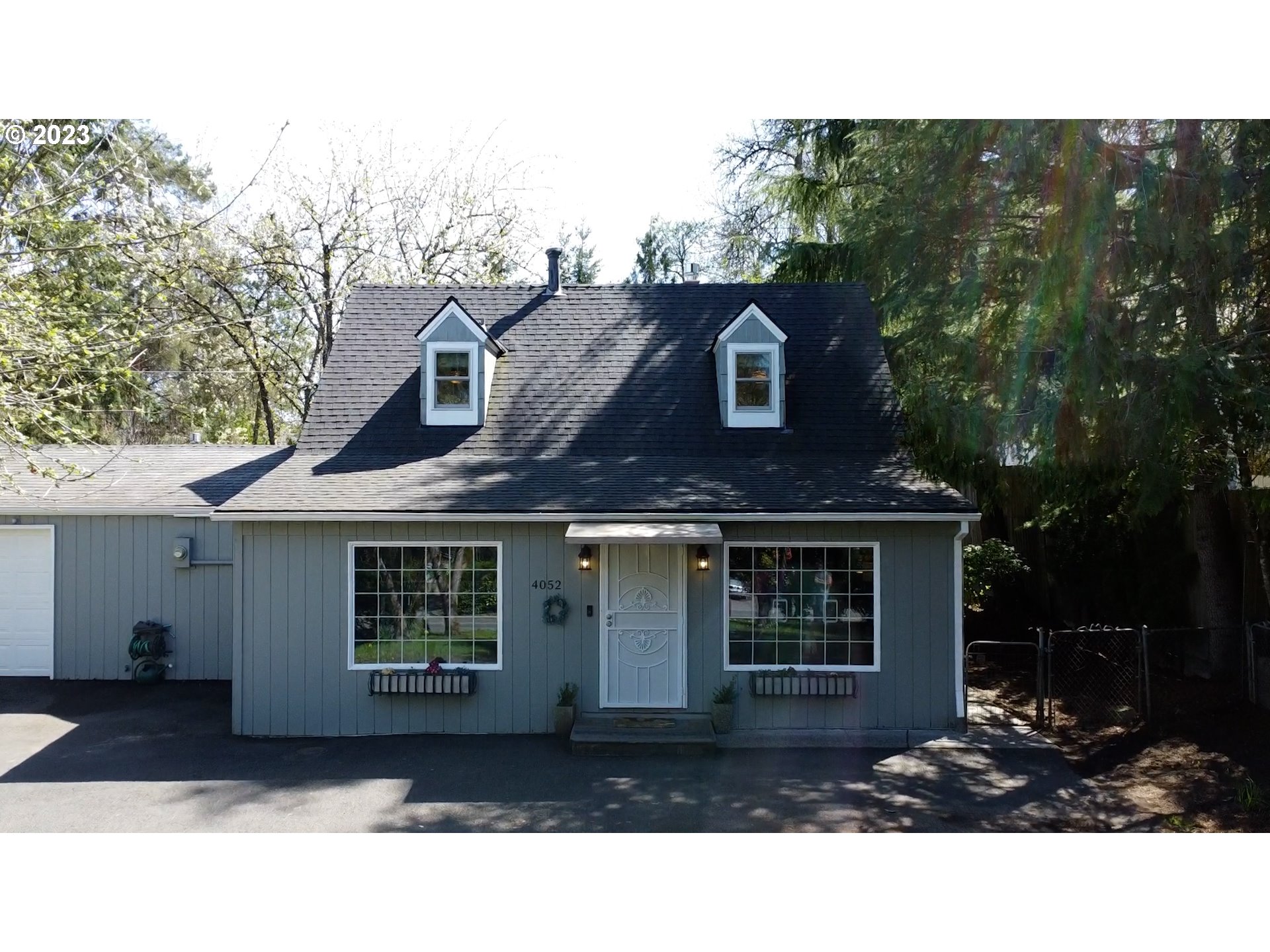4052 Southwest Huber Street Portland, OR 97219 - Photo 7 of 48 a front view of a house with a yard