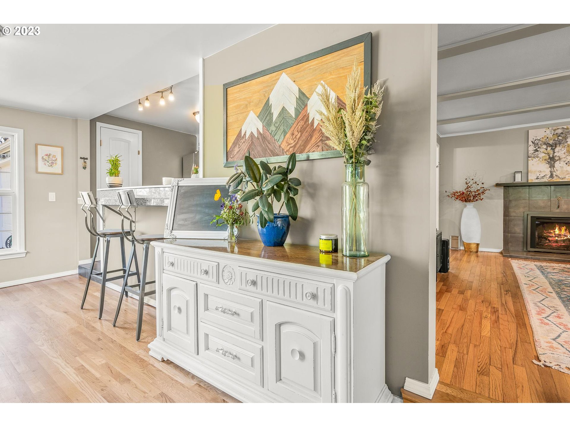 4052 Southwest Huber Street Portland, OR 97219 - Photo 10 of 48 a living room with furniture a fireplace and a potted plants