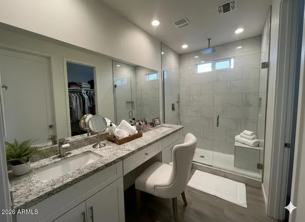 a bathroom with a granite countertop sink a toilet and shower