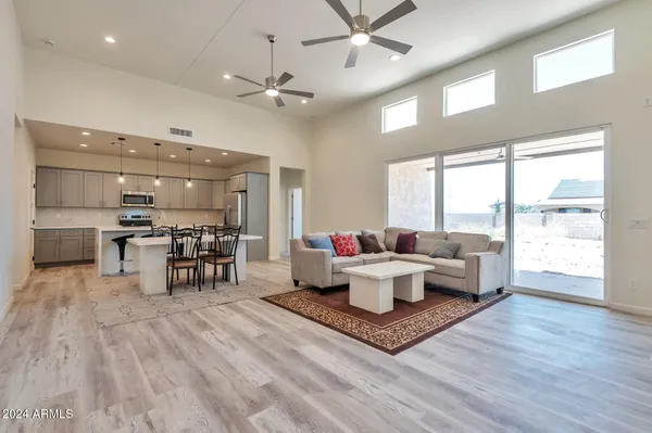a living room with furniture a table and chairs