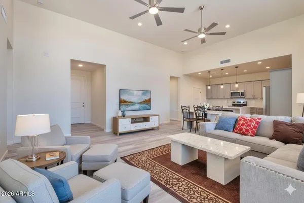 a living room with furniture and a view of kitchen