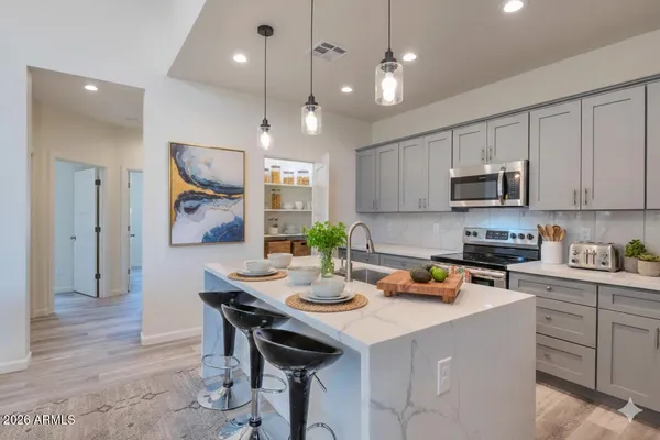a kitchen with a sink stove and microwave