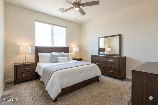 a bedroom with a bed and a tv