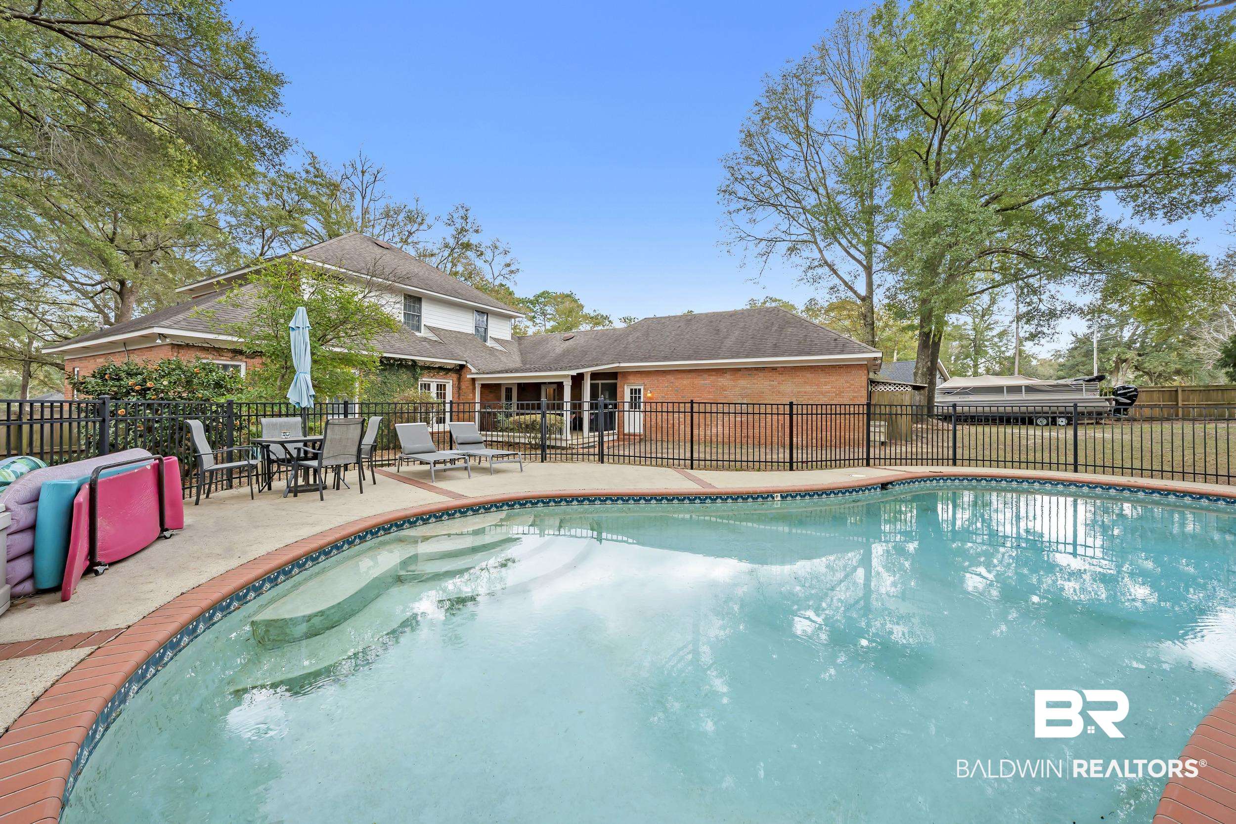 2858 Postoak Circle Mobile, AL 36693 - Photo 8 of 32 View of pool featuring a patio area, a fenced backyard, and outdoor dining area
